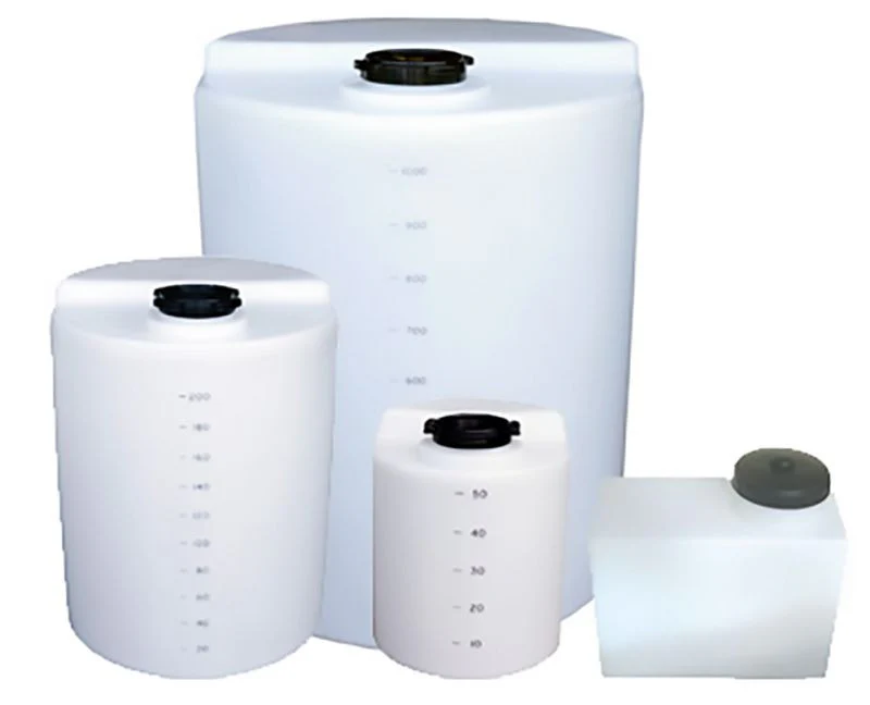 White plastic storage tanks with black lids and measurement markings.