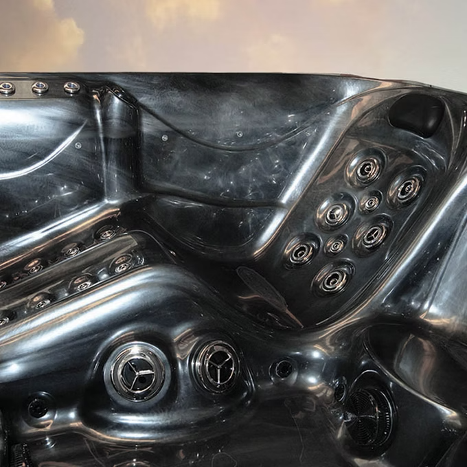 Black acrylic hot tub with chrome-plated jets and molded contours.
