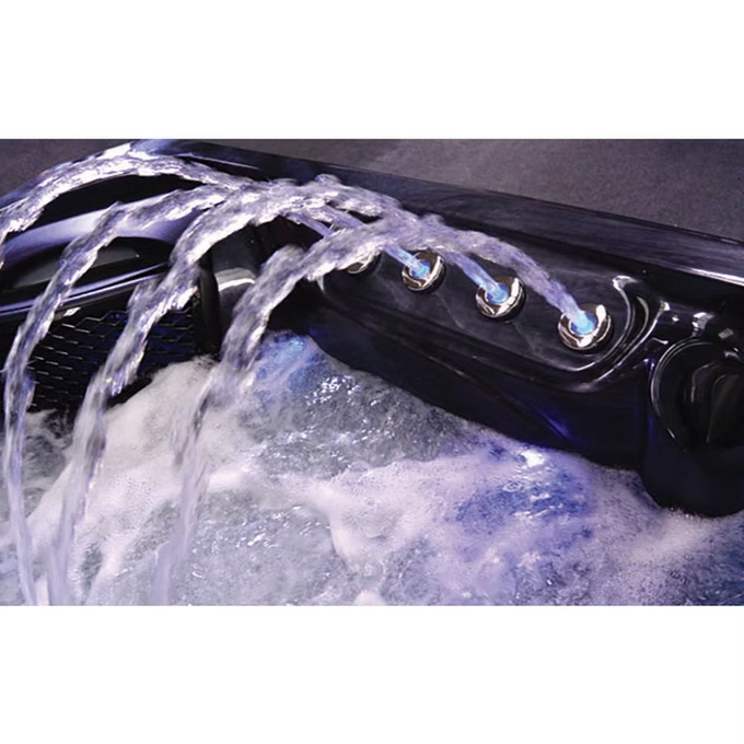 Black hot tub with multiple water jets emitting streams of clear, foamy water.