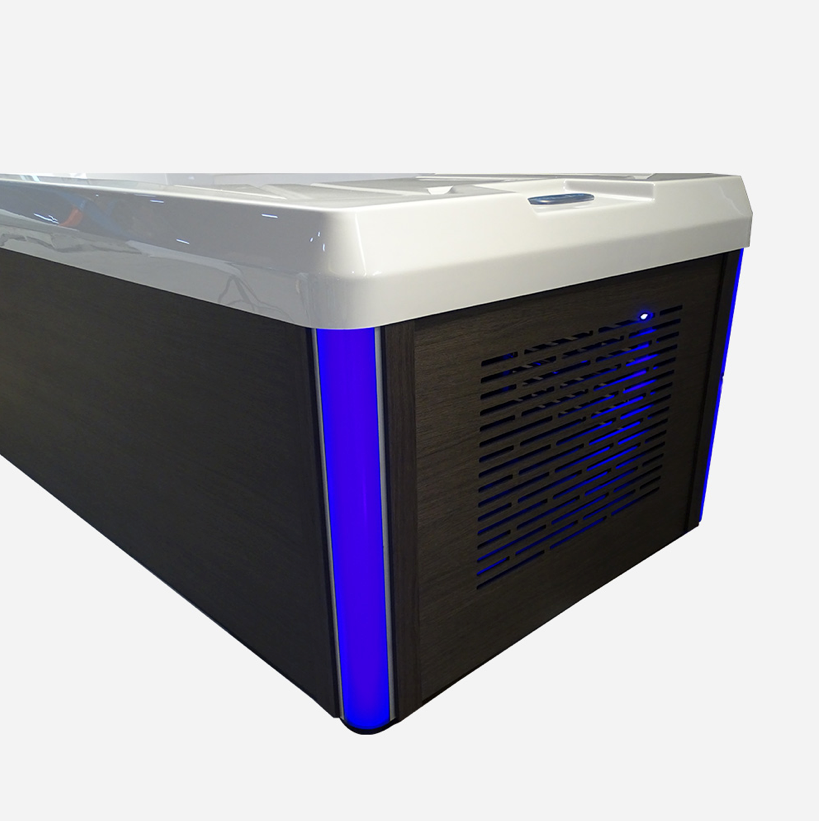 Modern white and black hot tub with blue led lighting along its side.