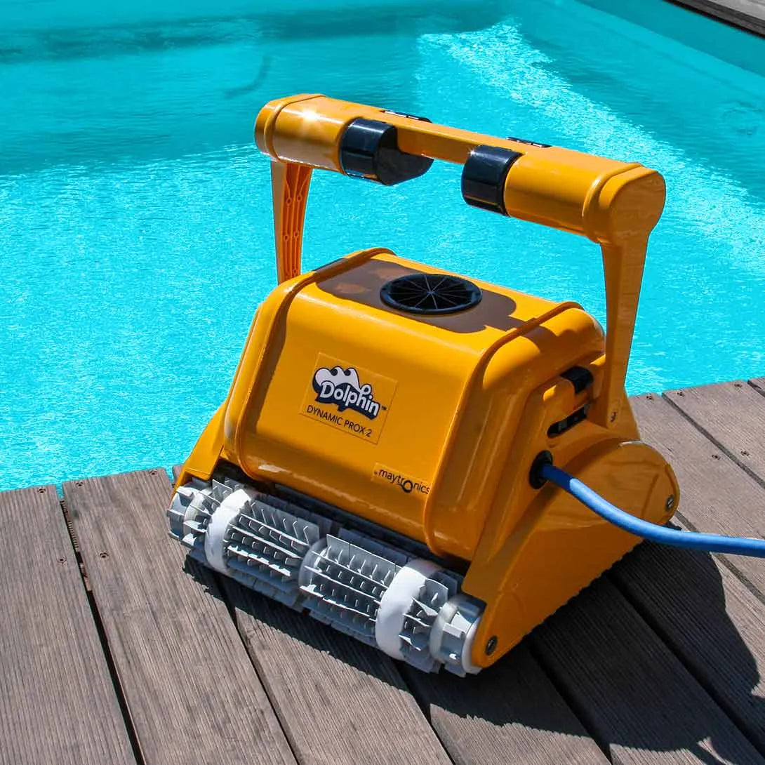 Yellow dolphin dynamic pro 2 robotic pool cleaner with a black logo and silver brush rollers.