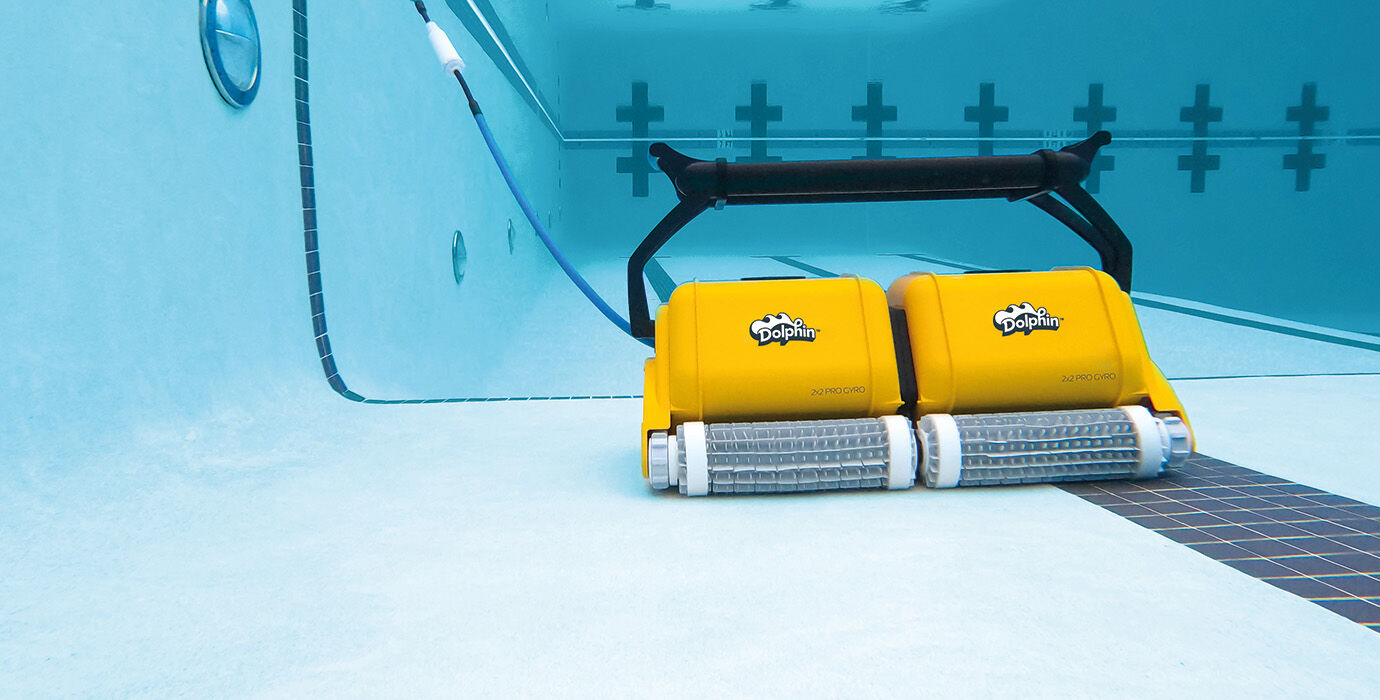 Yellow robotic pool cleaner with black handle and silver brush rollers, branded ’dolphin.’