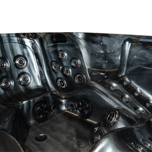 Black hot tub with glossy finish and multiple circular jet nozzles.