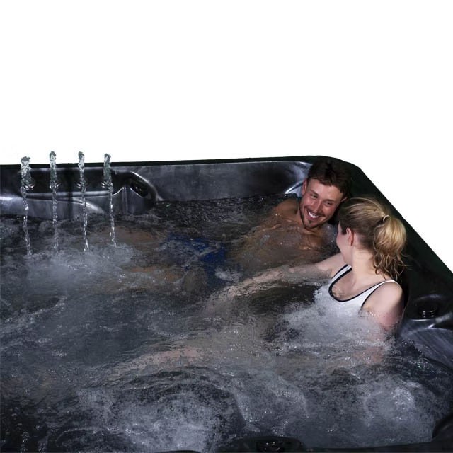 Black hot tub with water jets and bubbling water