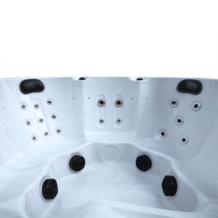 White hot tub with black jets and circular massage nozzles.