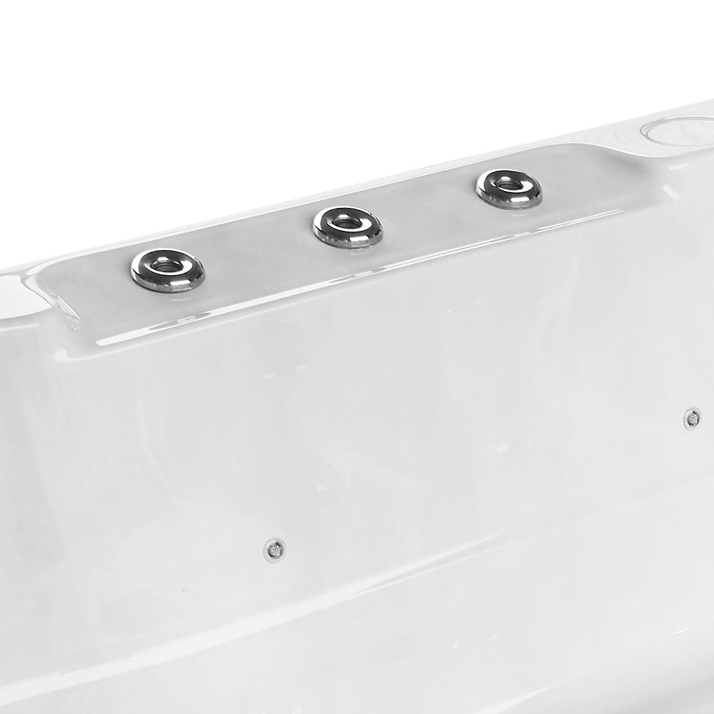 White acrylic hot tub with three chrome-finished jet nozzles along its curved edge.