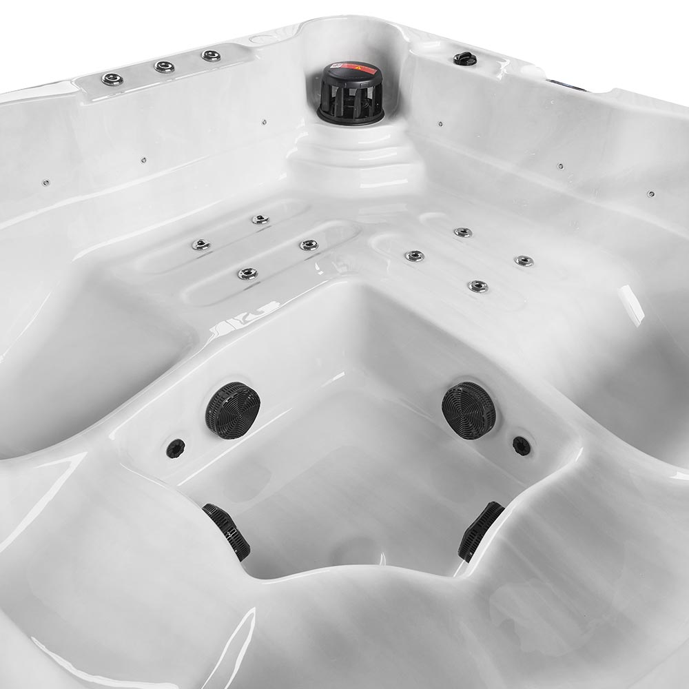 White hot tub with black jets and a central control knob.