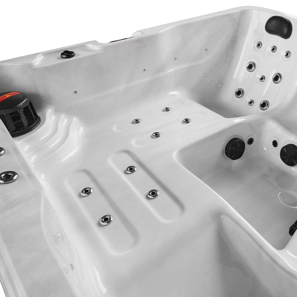 White hot tub with black jets and a black control knob.
