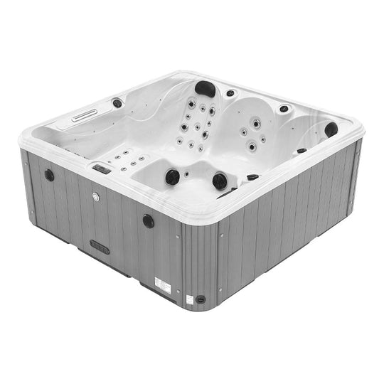 Gray and white hot tub with black jets and control panel.