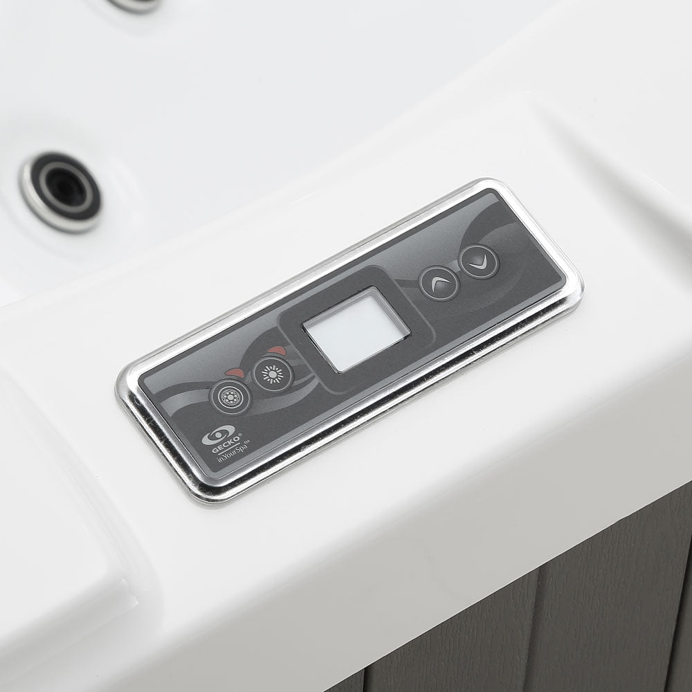 Silver-framed control panel with black display and buttons for a white hot tub.