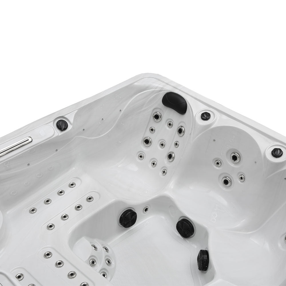 White hot tub with black jets and silver-toned water spray nozzles.