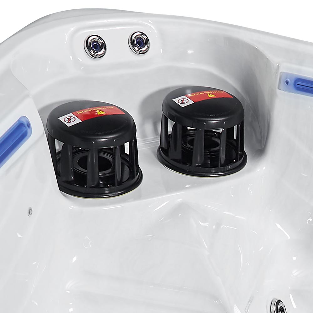 Black plastic jet covers with red warning labels sit inside a white hot tub.