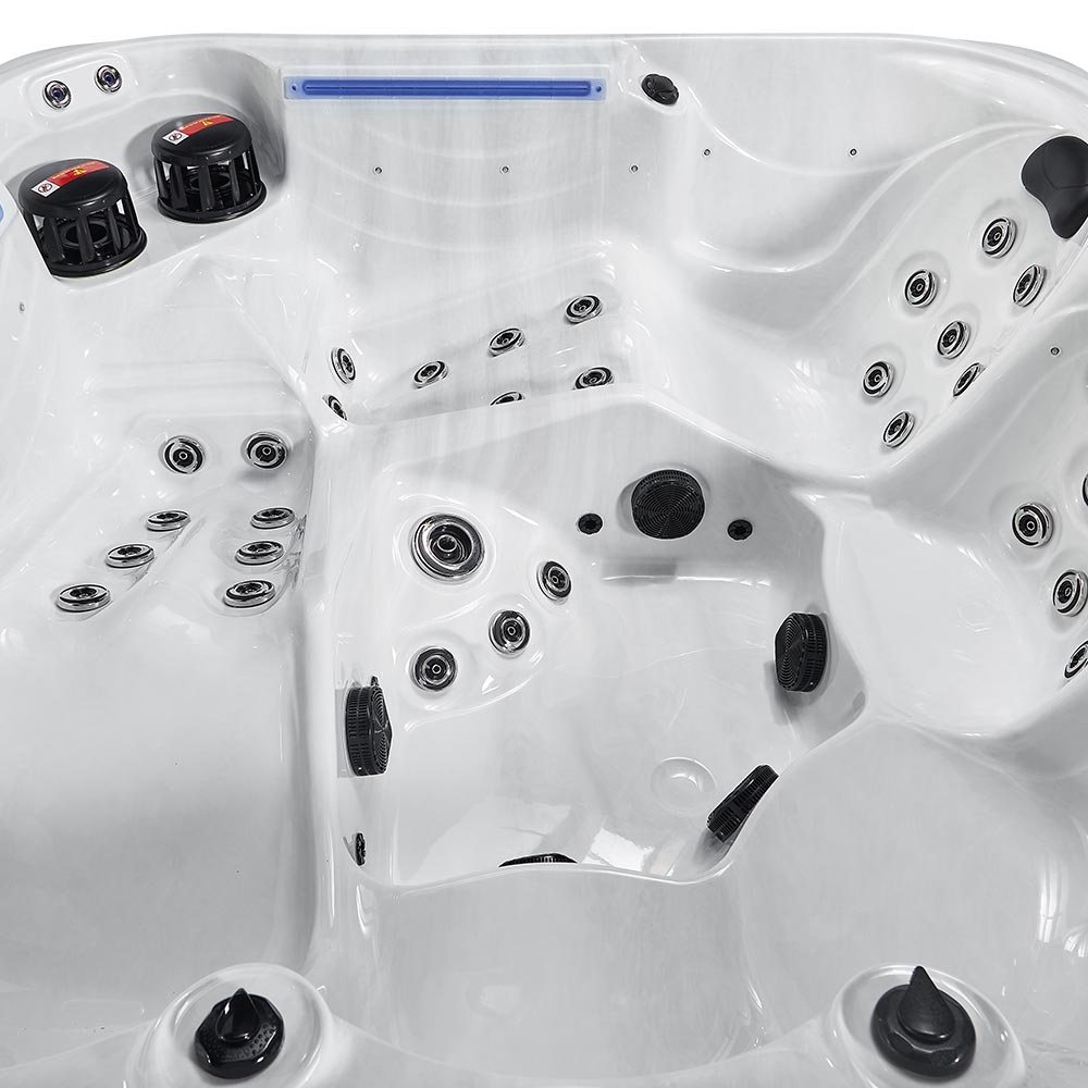 White hot tub with black jet nozzles and a blue light strip.