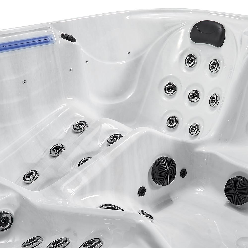 White hot tub with chrome and black jet nozzles.