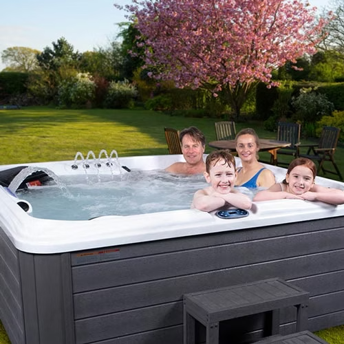 Gray slatted hot tub with white interior and water jets