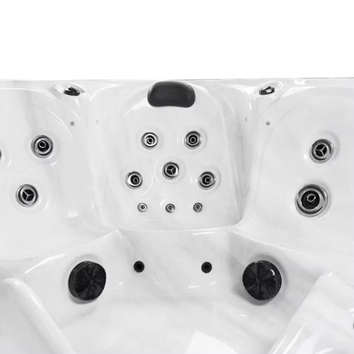 White hot tub with black jet nozzles and a central headrest.