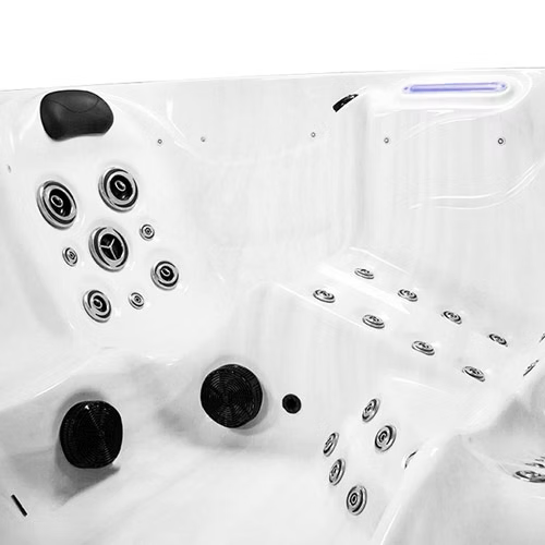 White hot tub with black jets and silver circular massage nodes.