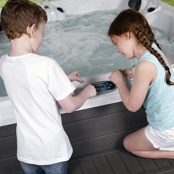 White hot tub control panel with digital display and black buttons