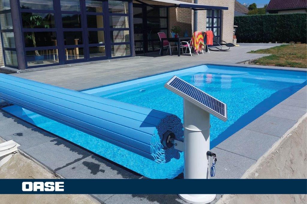 Blue solar-powered pool cover with a sleek, modern design and white motorized base.