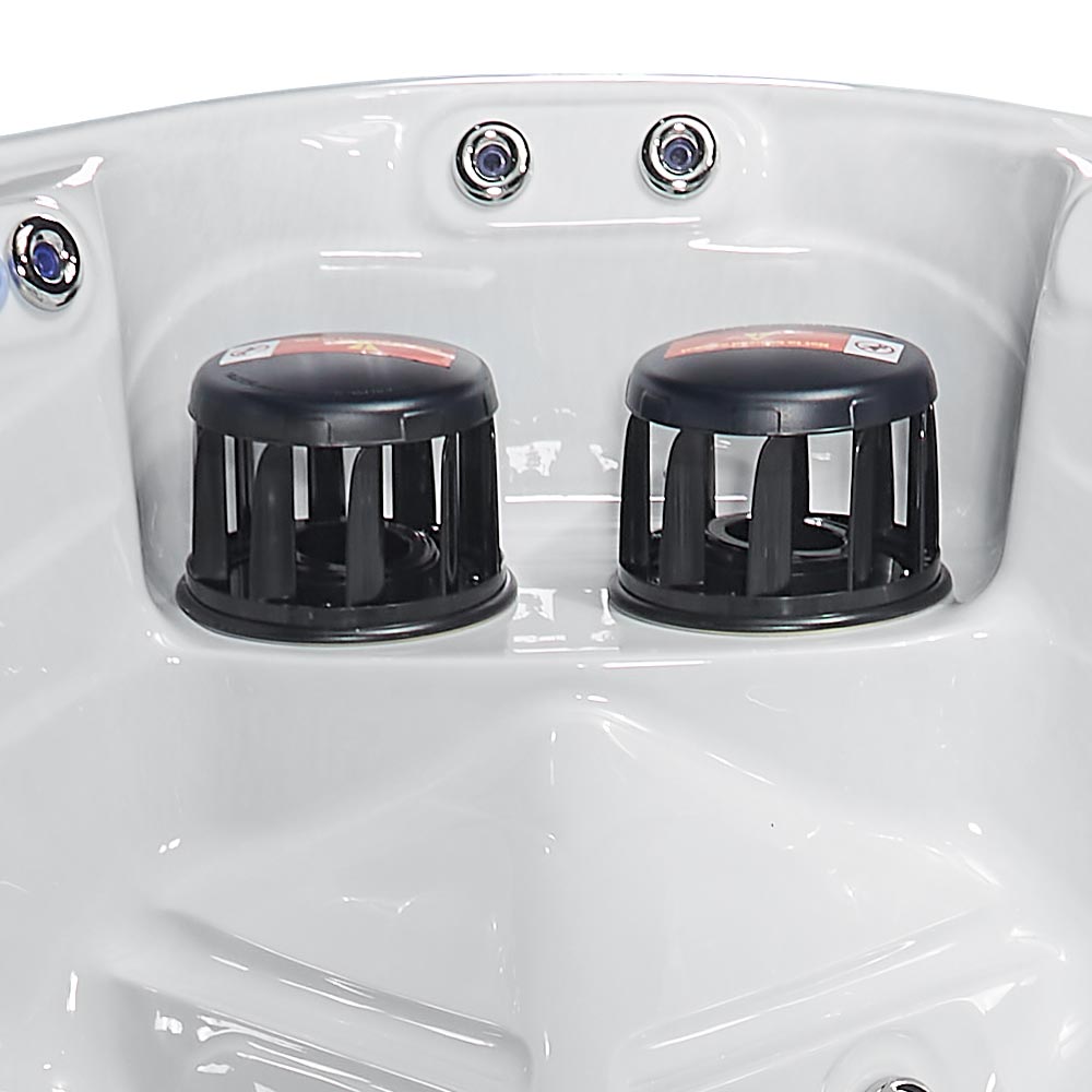 Black plastic jet covers with a ribbed, cylindrical design sit in the white molded basin of a hot tub.