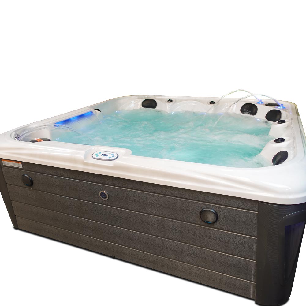 Modern hot tub with a white upper shell and dark gray wood-grain lower panel, featuring black jet nozzles and blue led lighting.