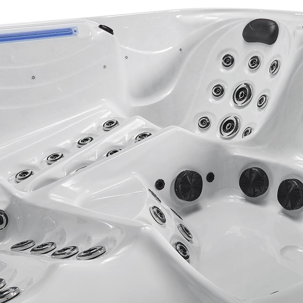 White hot tub with chrome and black jet nozzles.