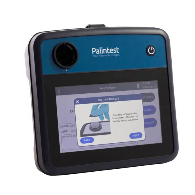 Blue and black palintest water analysis instrument with a touchscreen display showing instructional steps.