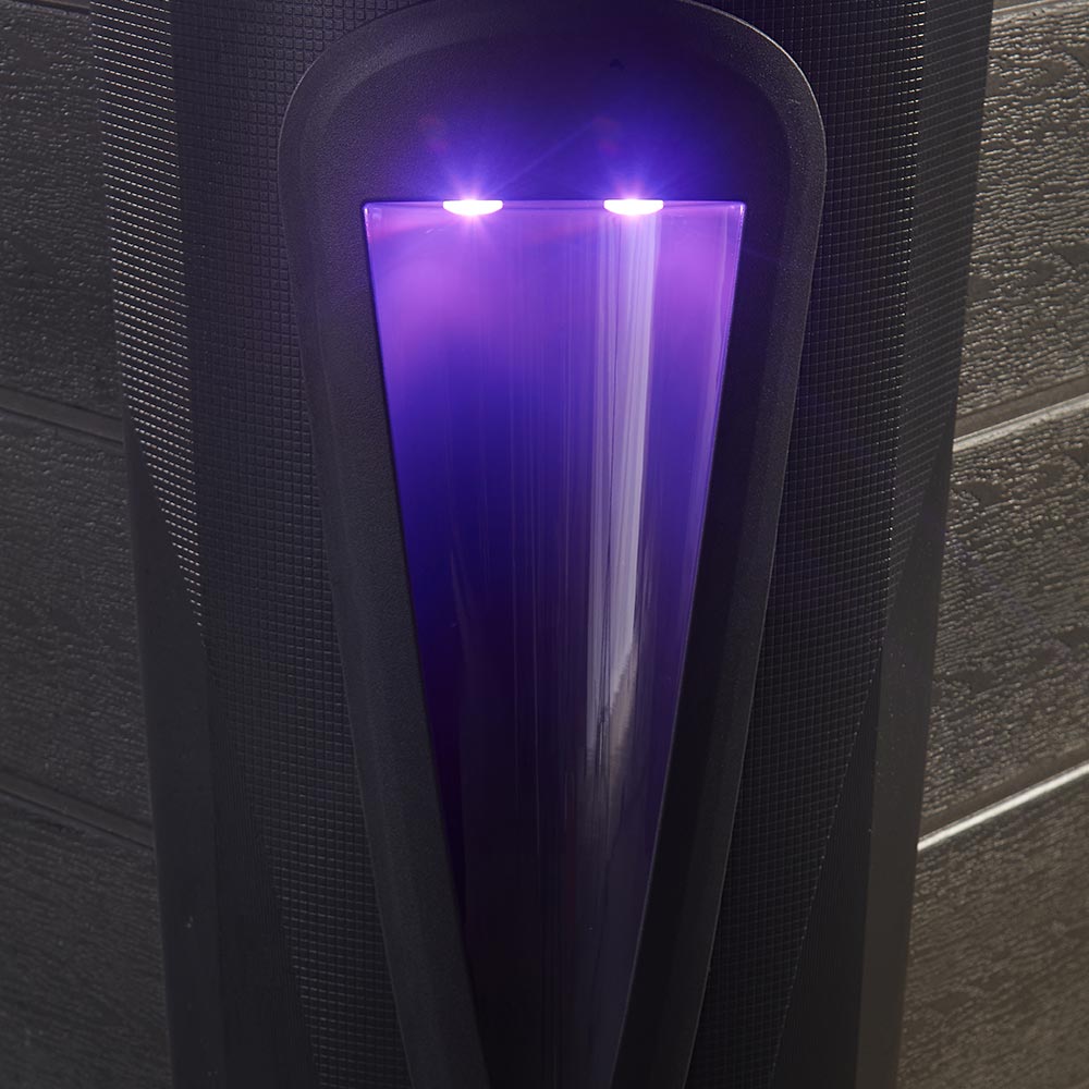 Black speaker with a glowing purple light panel.