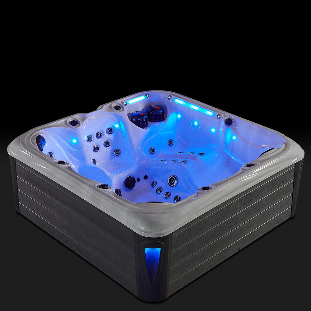 A modern, square-shaped hot tub with a sleek gray exterior and glowing blue interior lighting.