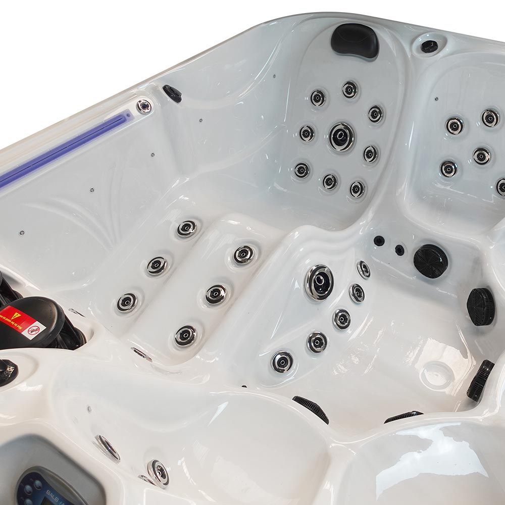 White hot tub with black and silver jet nozzles.