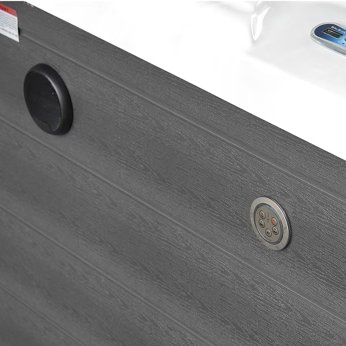 Dark gray wood-grain textured side panel of a hot tub featuring circular control buttons and speaker grilles.