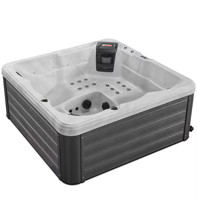 Gray and white hot tub with a sleek, modern design featuring integrated jets and a control panel on the side.