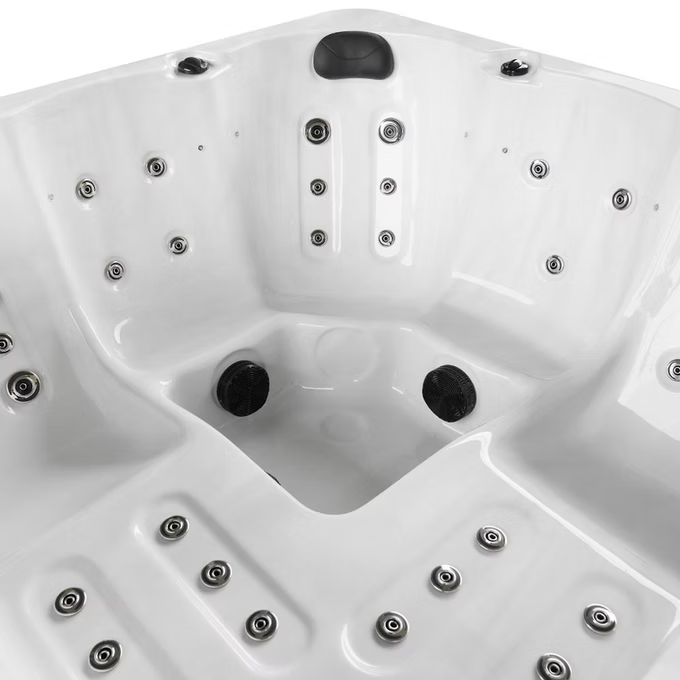 White hot tub with black jet nozzles and silver-toned circular jets.