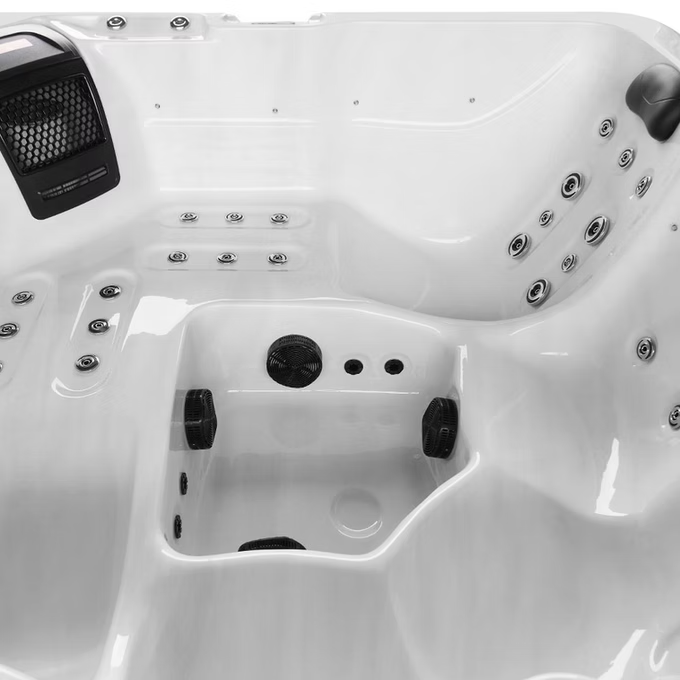 White hot tub with black jets and control panel.