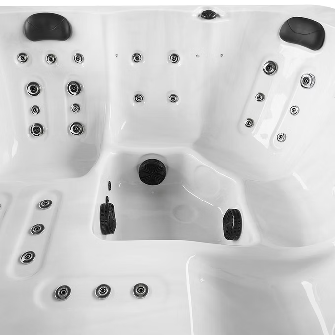 White hot tub with black jets and headrests.