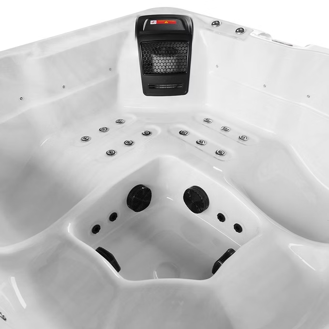 White hot tub with black jets and a built-in heater unit.