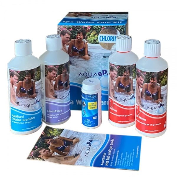 Aquaspa spa water care kit featuring bottles with white caps and labels showing smiling people in a pool, alongside a box labeled ’chlorine’ and an instruction booklet.