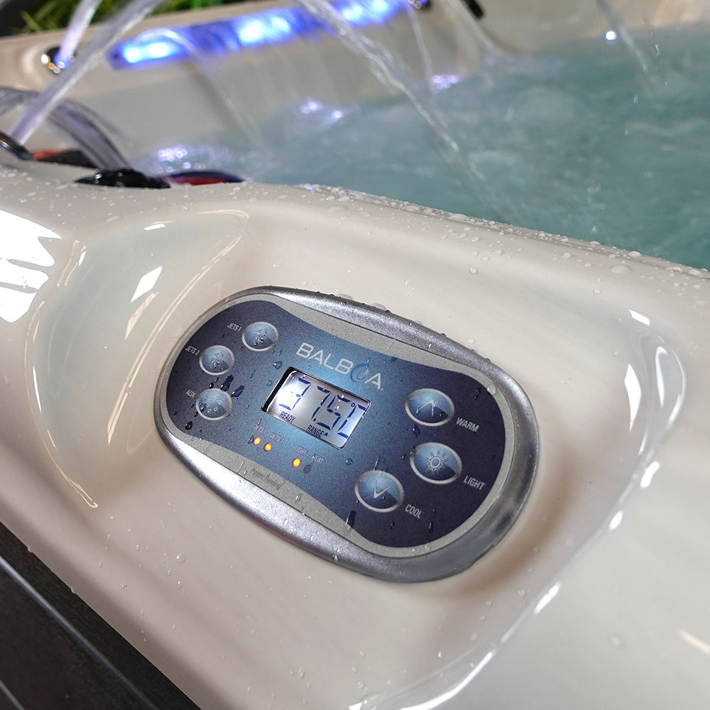 Silver and black digital control panel for a balboa hot tub, featuring illuminated buttons labeled with functions like warm, cool, light.