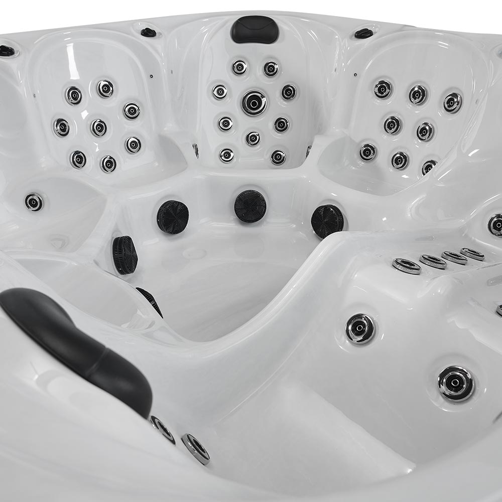 White hot tub with black jets and chrome accents.