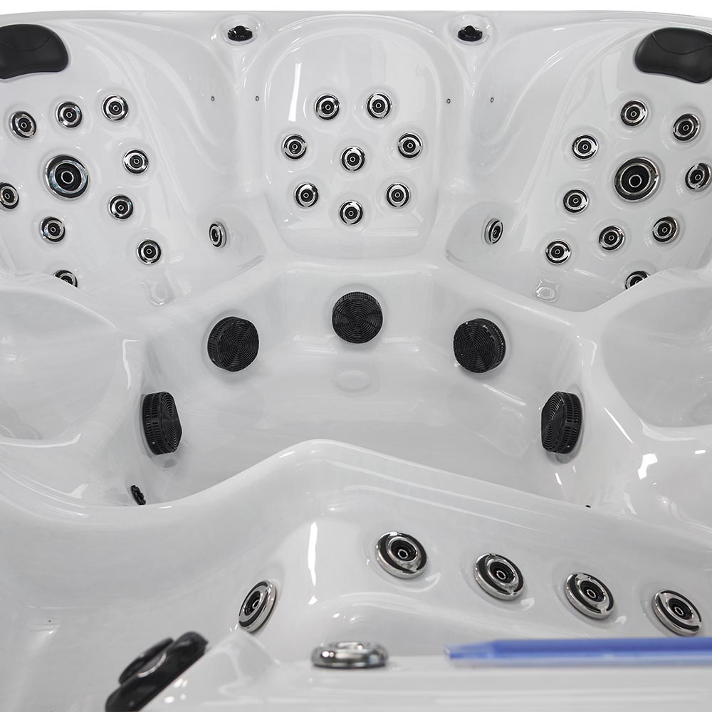 White hot tub with black and silver jet nozzles.