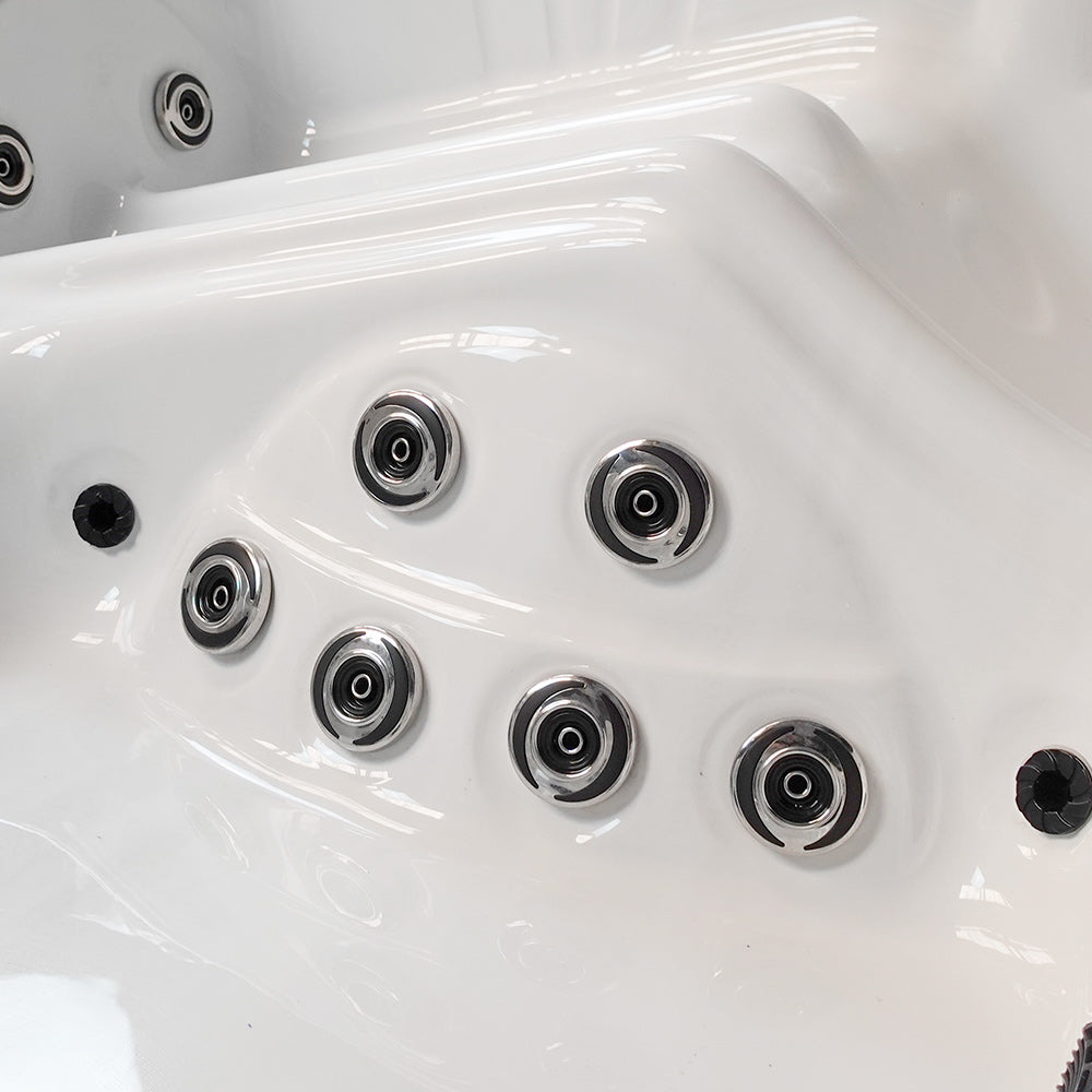 White hot tub with chrome-finished jet nozzles.
