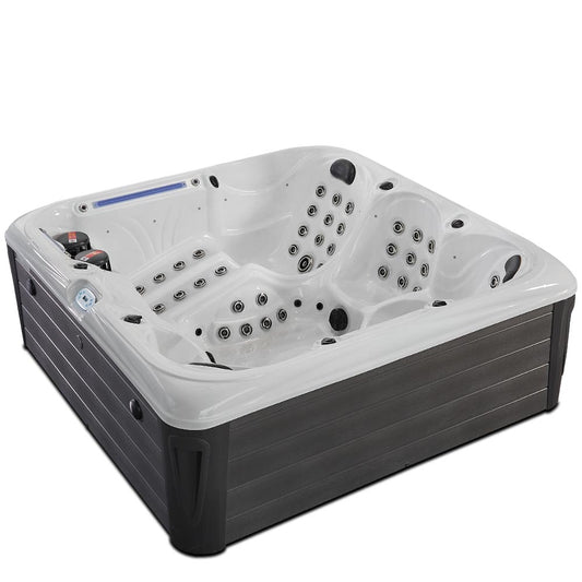 White and dark gray hot tub with multiple jet nozzles for hydrotherapy.
