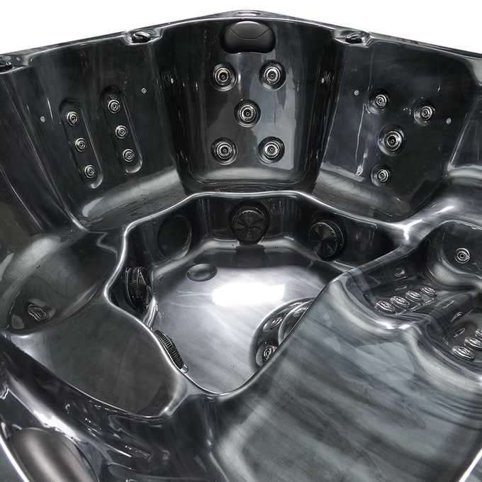 Black acrylic hot tub with multiple jet nozzles and a sleek, modern design.
