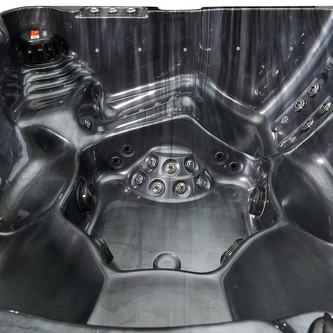 Black molded plastic hot tub with integrated jet nozzles and a sleek, modern design.