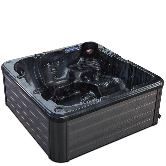 Black hot tub with molded seating and jet nozzles.