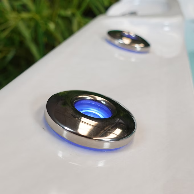 Circular chrome-finished button with a glowing blue light in the center.