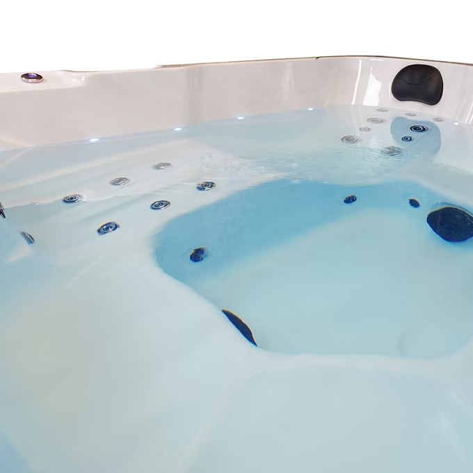 White hot tub with blue water and black jets