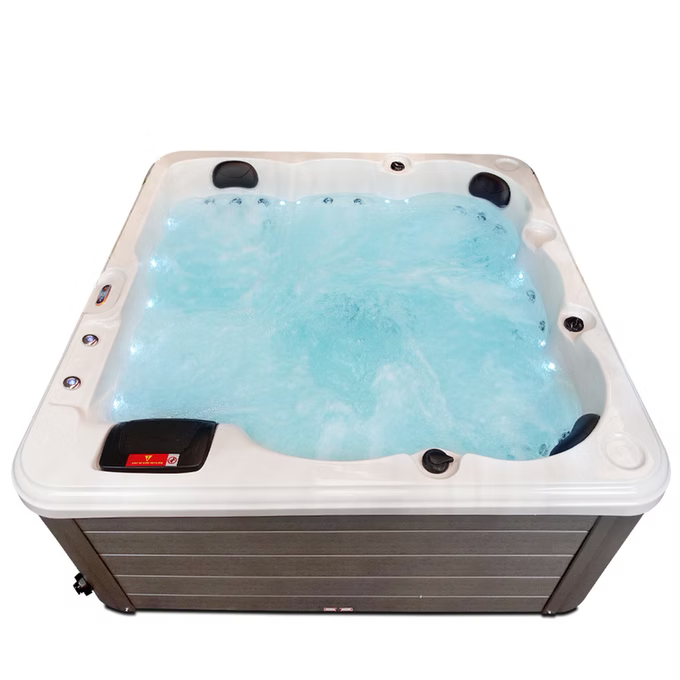White and gray hot tub with blue water, featuring black control panels and jets.