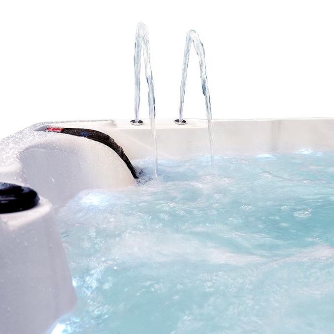 White hot tub with two arched water jets spraying clear blue water.