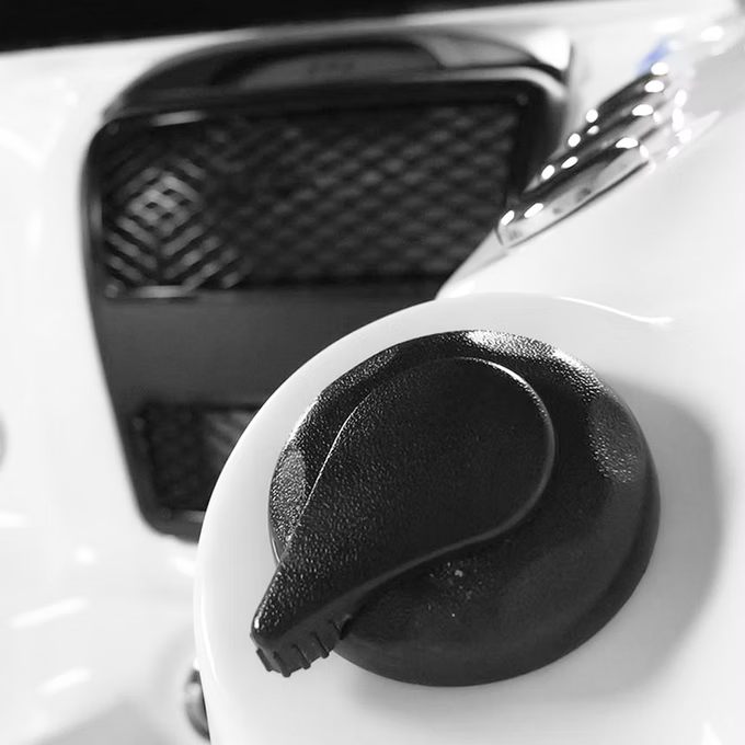 Black textured fuel cap with a teardrop-shaped handle.